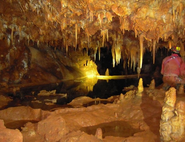  Cuenca Cave with man on his back 